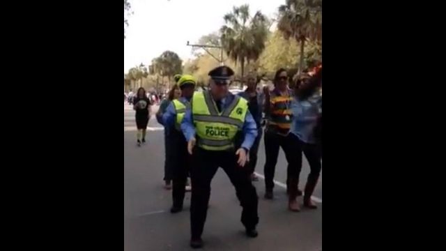 New Orleans Police officer does the Wobble dance during Mardi Gras 2014